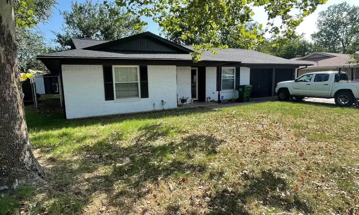 Professional roofing crew working on a residential roof in Warr Acres